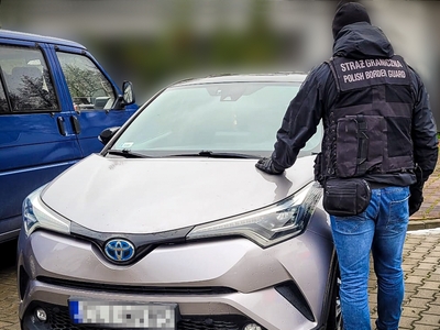 Funkcjonariusz SG zabezpiecza auto