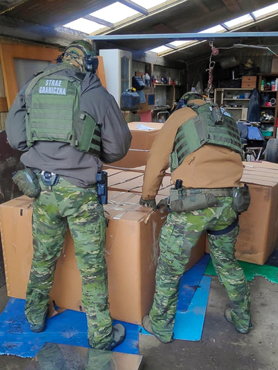 Funkcjonariusze zabezpieczają kartony z suszem tytoniowym 