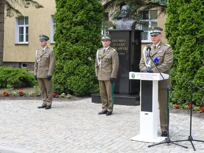 Komendant Główny SG przemawia podczas uroczystości zmiany na stanowisku Komendanta Warmińsko-Mazurskiego Oddziału Straży Granicznej, za nim stoją ustępujący Komendant WMOSG z nowym Komendantem WMOSG Komendant Główny SG przemawia podczas uroczystości zmiany na stanowisku Komendanta Warmińsko-Mazurskiego Oddziału Straży Granicznej, za nim stoją ustępujący Komendant WMOSG z nowym Komendantem WMOSG
