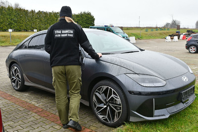 Funkcjonariuszka Straży Granicznej stoi przy zatrzymanym pojeździe Funkcjonariuszka Straży Granicznej stoi przy zatrzymanym pojeździe