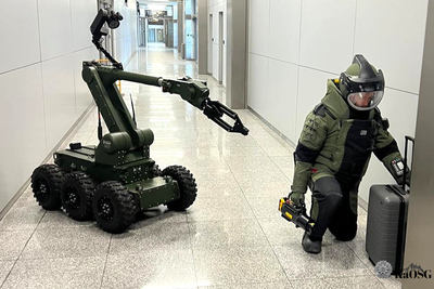 Pirotechnik sprawdza walizkę w asyście robota Pirotechnik sprawdza walizkę w asyście robota